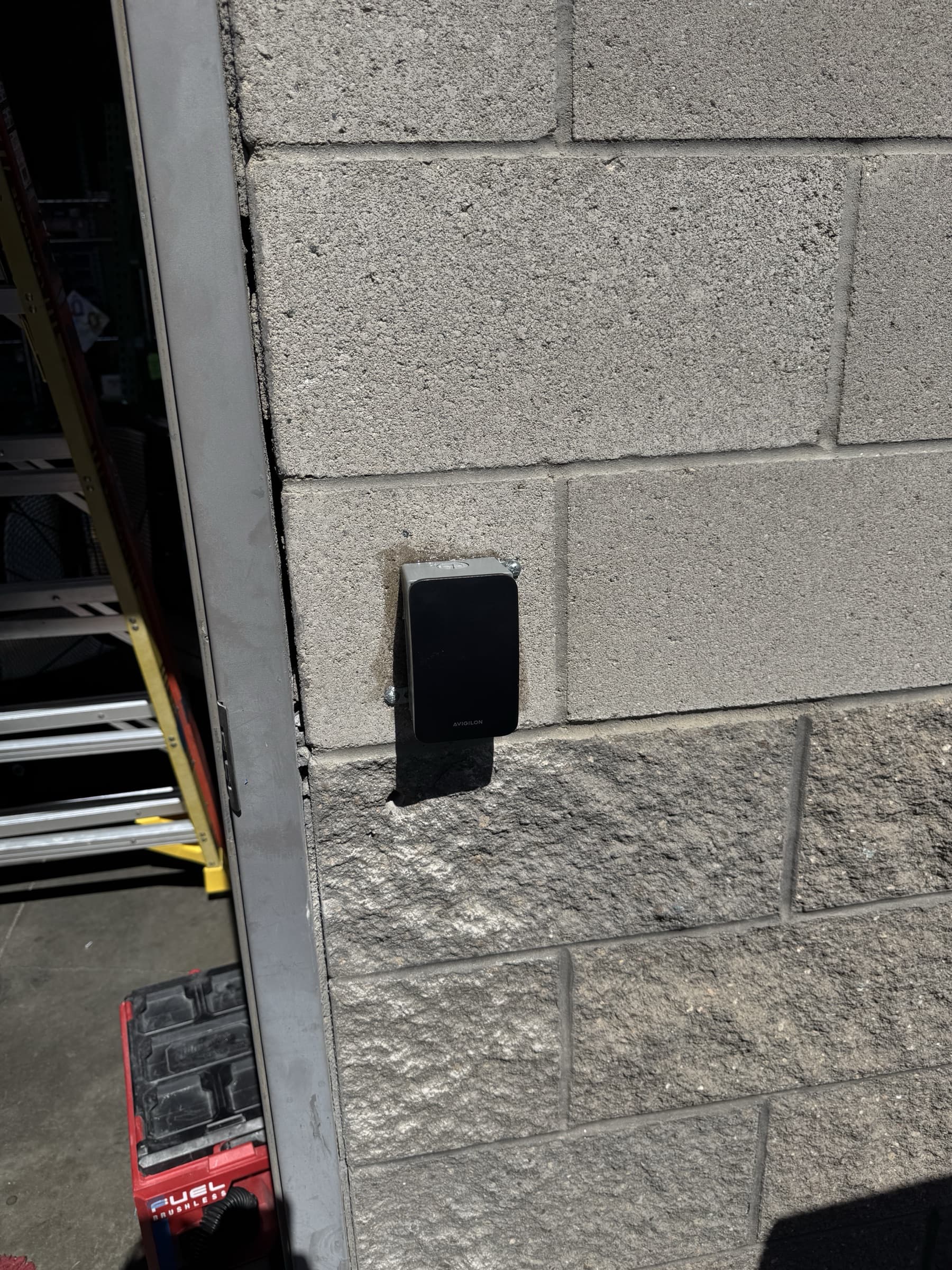 Commercial access control reader installed beside a business door