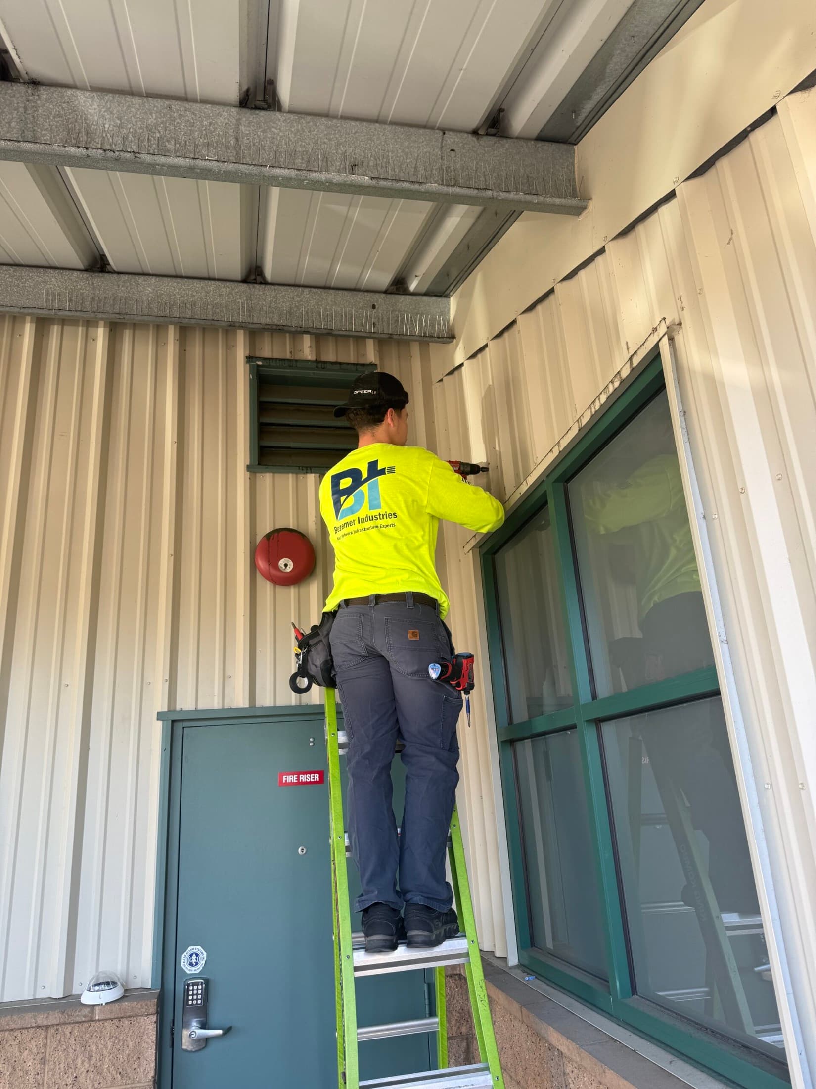 Bezemer technician installing commercial access control hardware