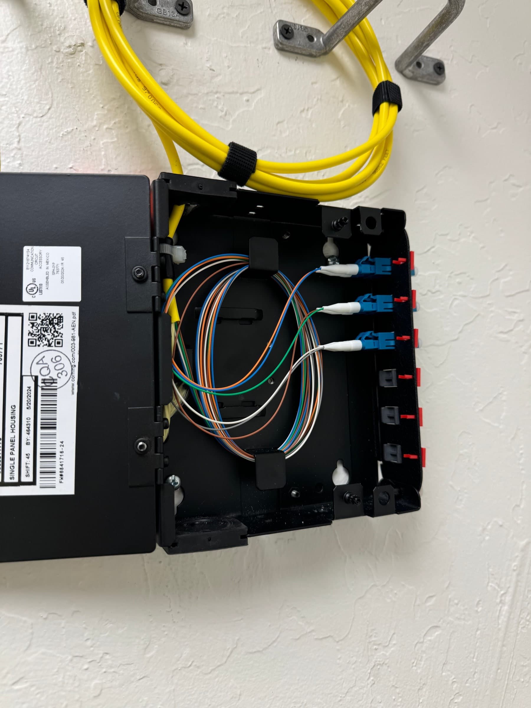 Commercial fiber optic cabling termination panel with bundled yellow fiber