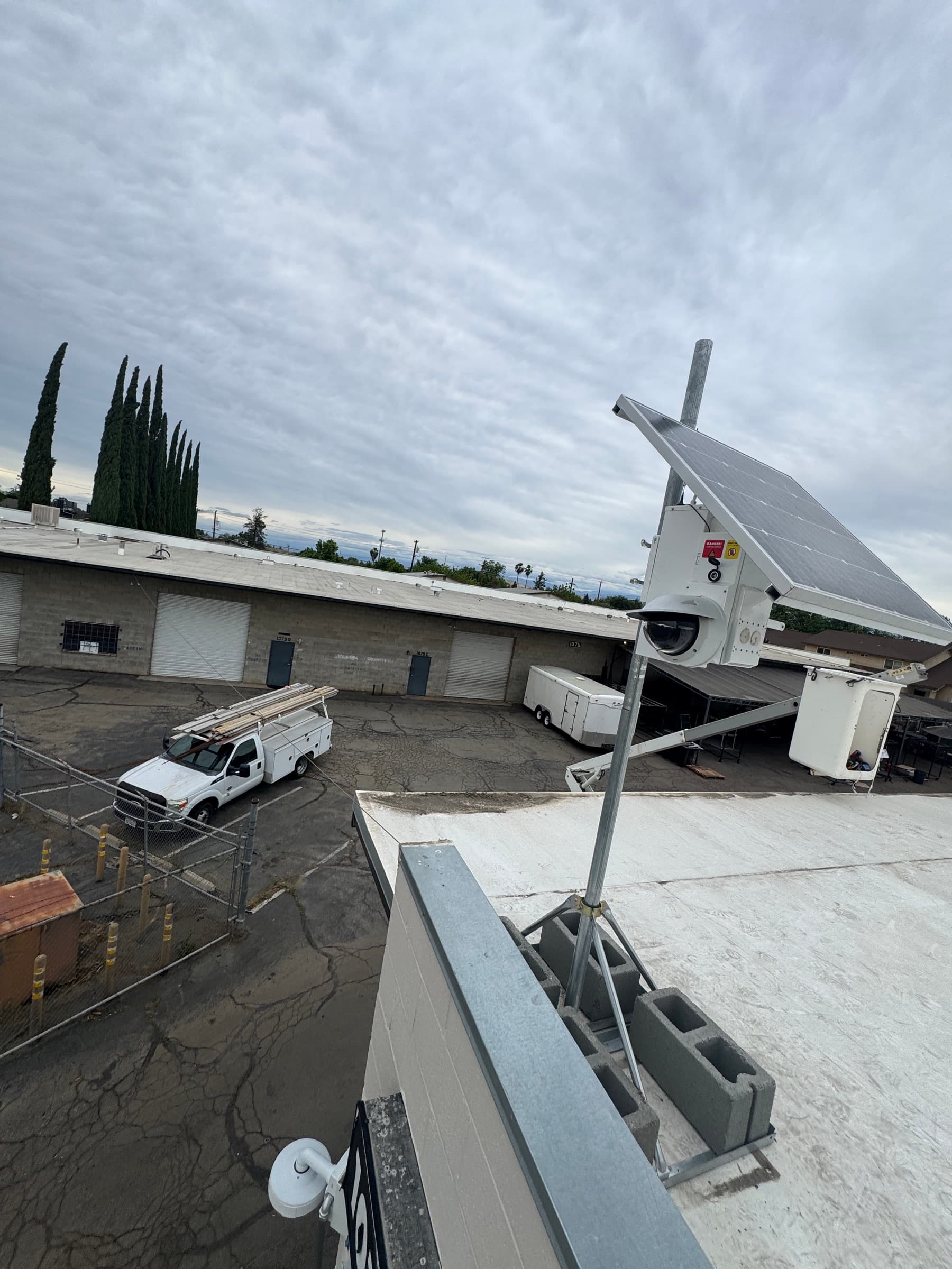 Commercial rooftop security camera and solar-supported equipment installation