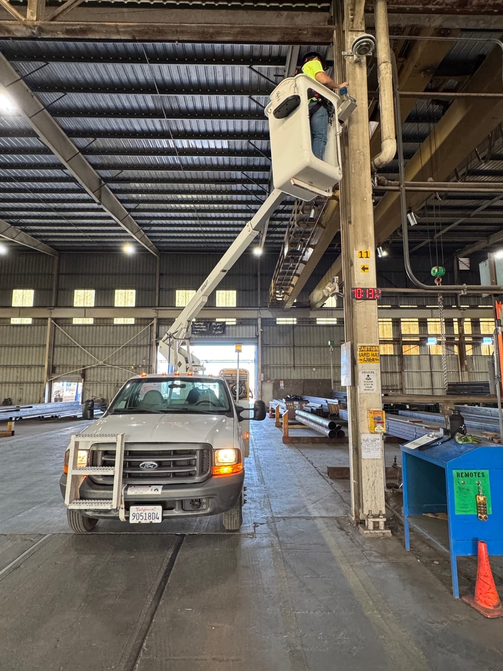Commercial security system bucket truck installation inside a warehouse facility