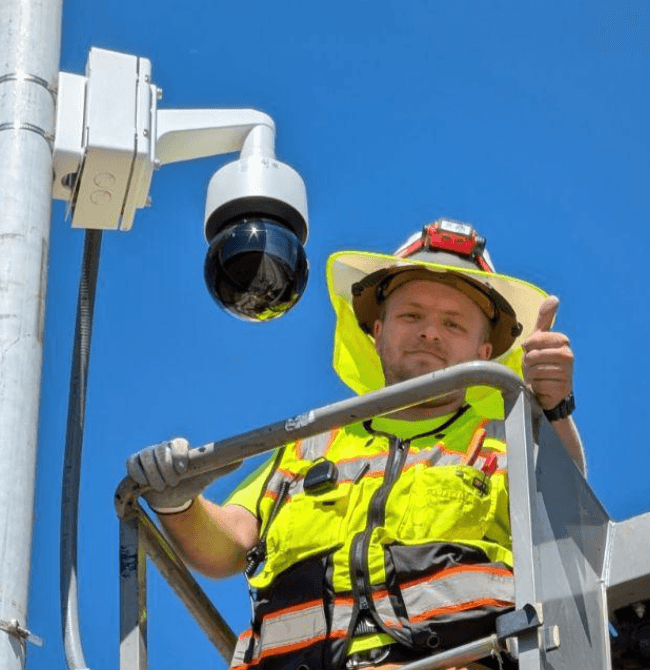 Ean Bezemer installing commercial camera equipment from a lift