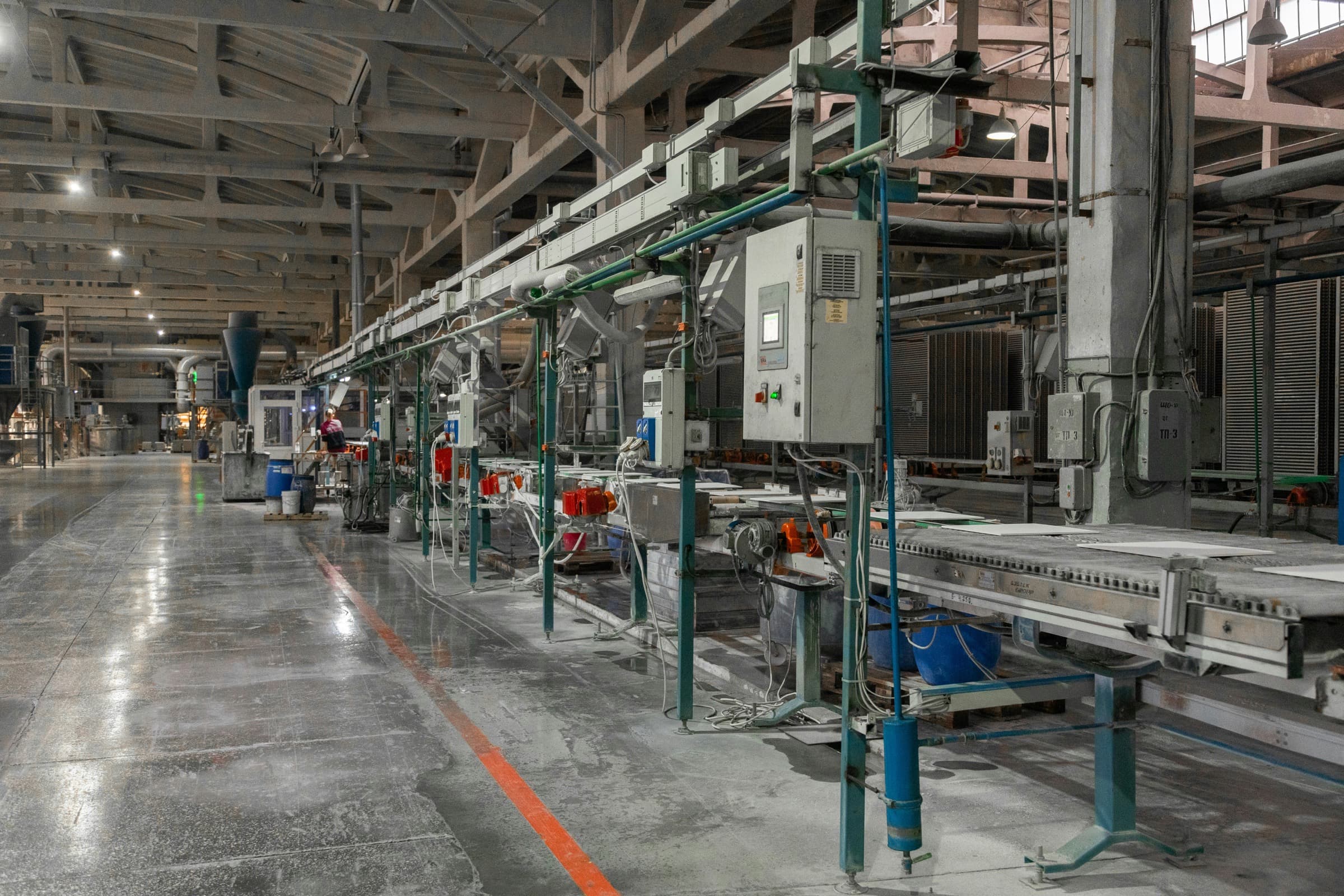 Manufacturing facility production floor with industrial equipment and conveyors