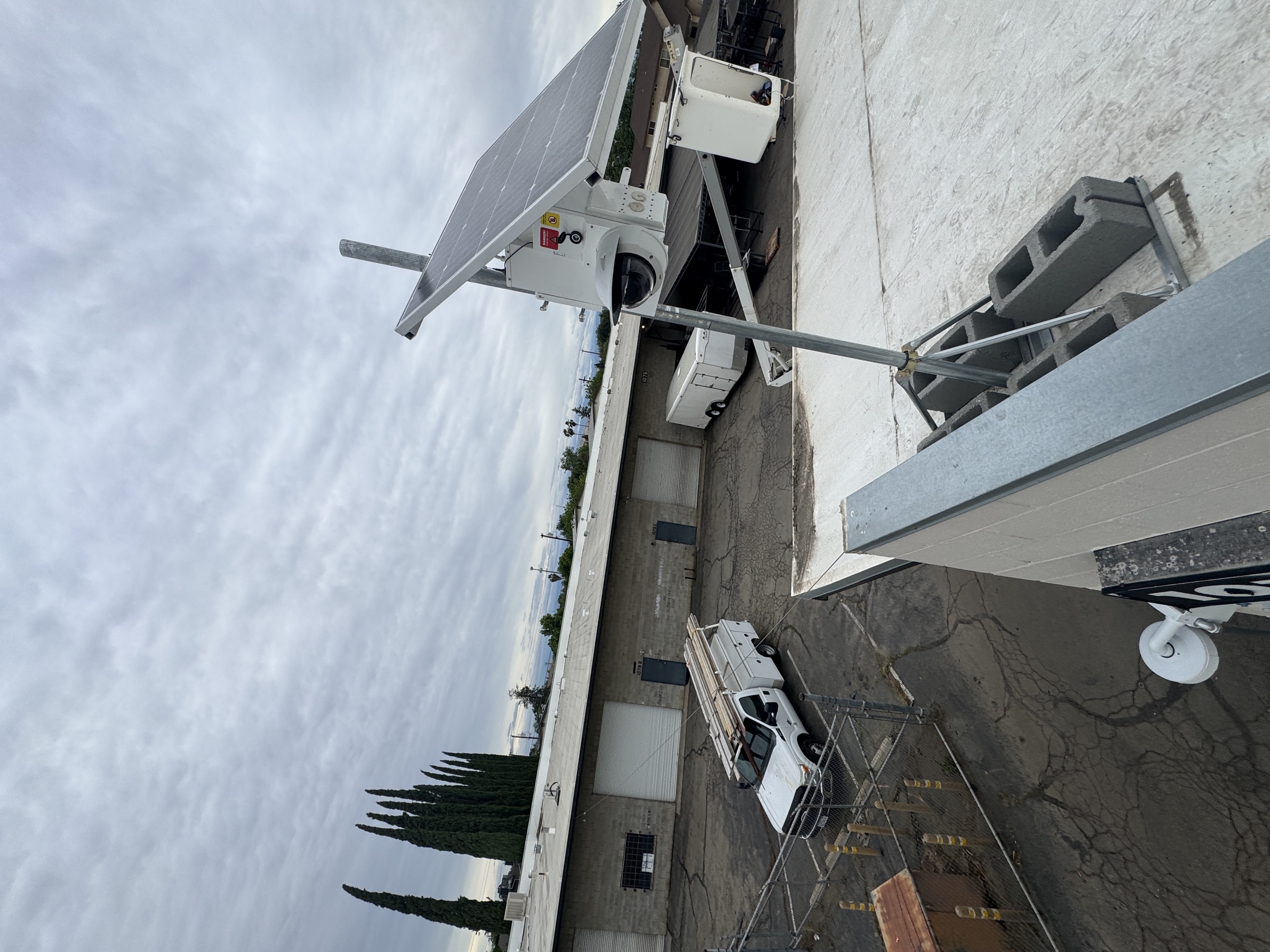 Commercial rooftop security camera and solar-supported equipment installation