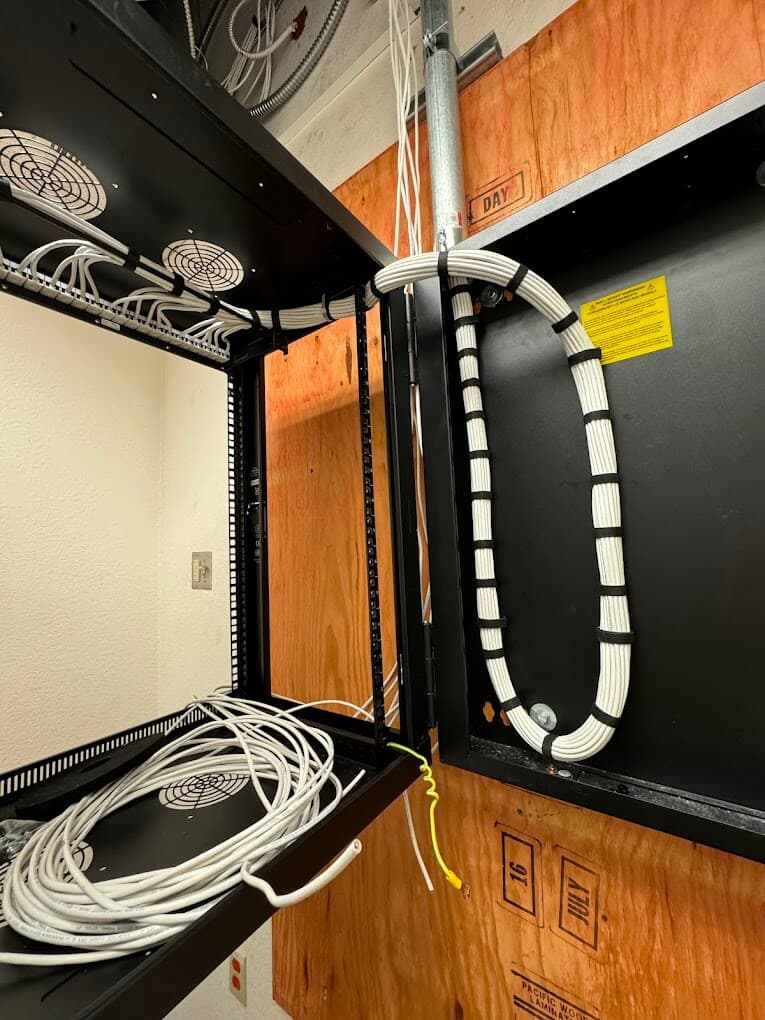 Structured cabling loop and rack pathway detail in a commercial low-voltage room